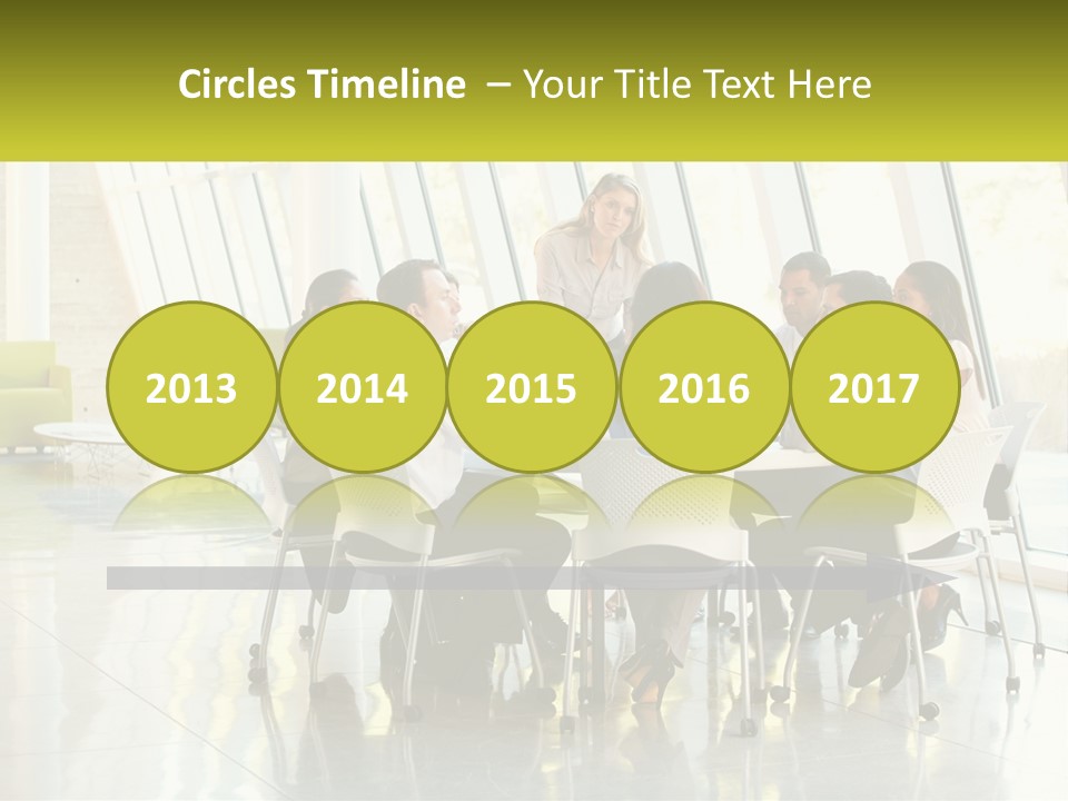 A Group Of People Sitting Around A Table Talking PowerPoint Template