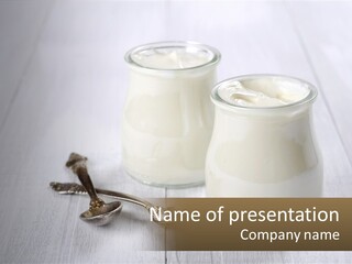 Two Jars Of Yogurt And A Spoon On A White Table PowerPoint Template