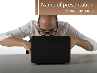 A Man Sitting In Front Of A Laptop Computer PowerPoint Template
