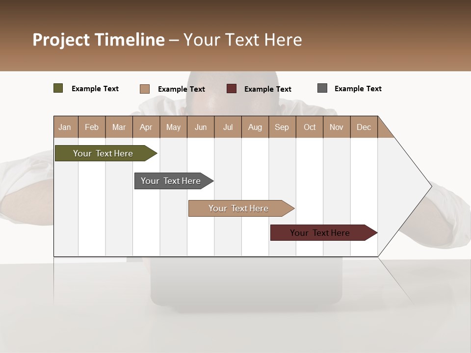 A Man Sitting In Front Of A Laptop Computer PowerPoint Template