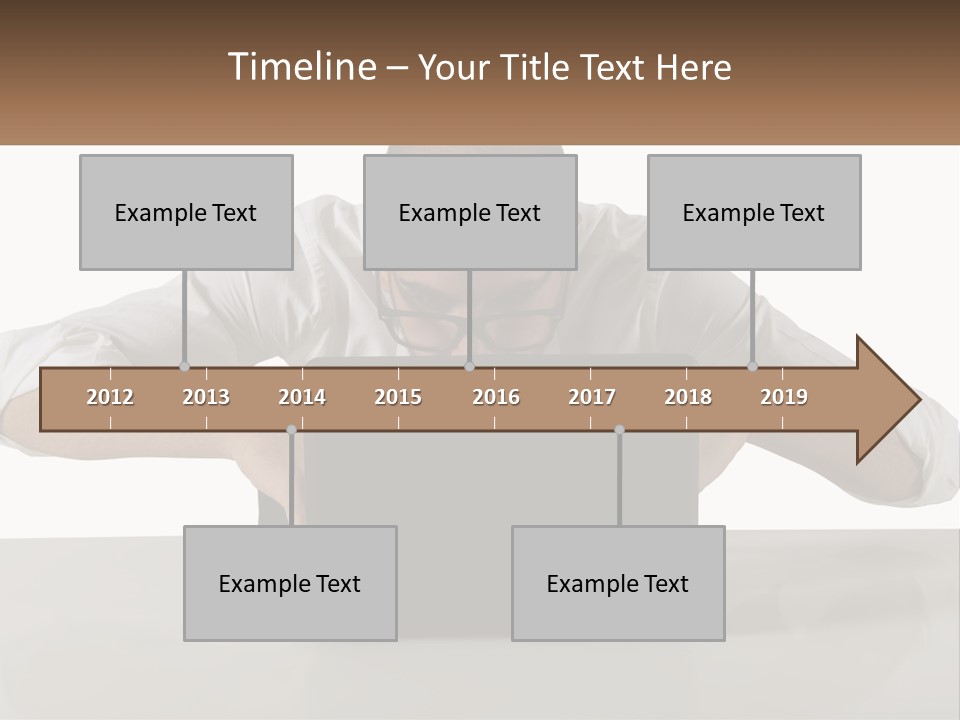 A Man Sitting In Front Of A Laptop Computer PowerPoint Template