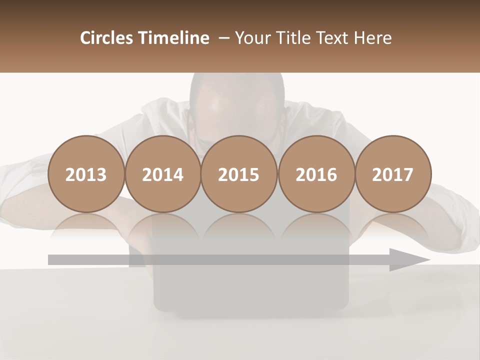 A Man Sitting In Front Of A Laptop Computer PowerPoint Template