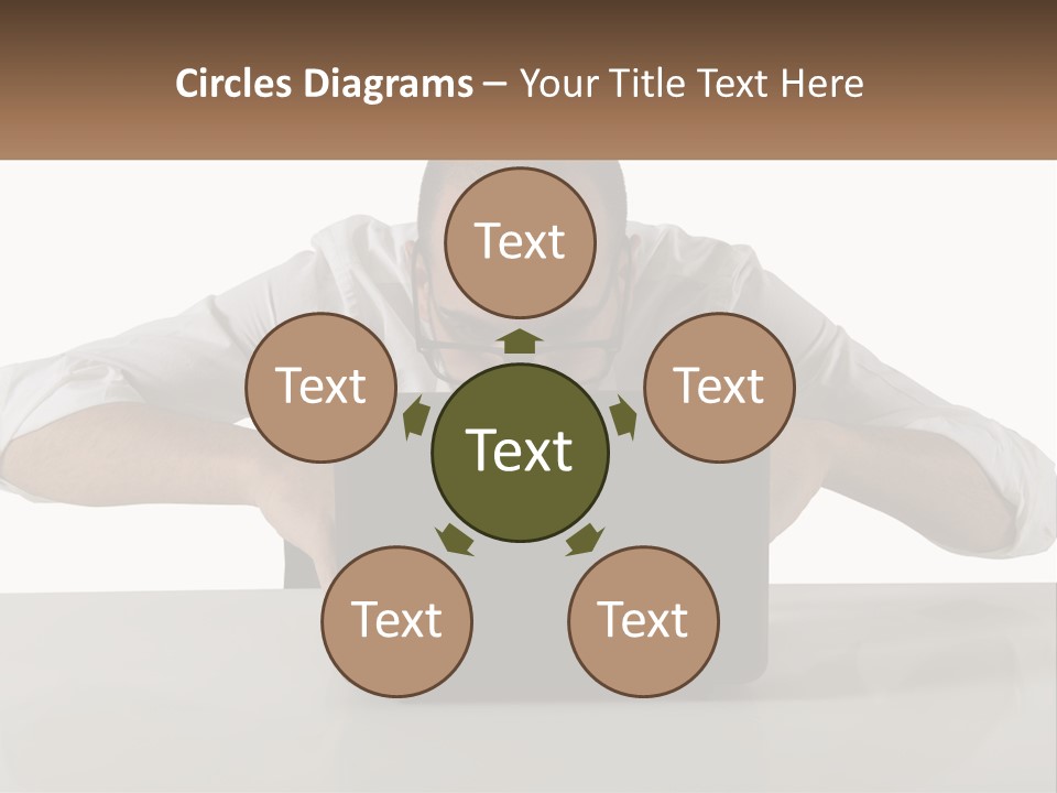A Man Sitting In Front Of A Laptop Computer PowerPoint Template