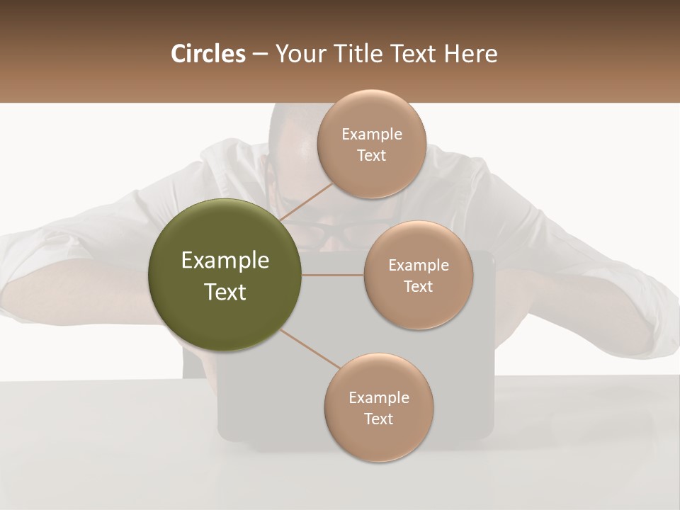 A Man Sitting In Front Of A Laptop Computer PowerPoint Template