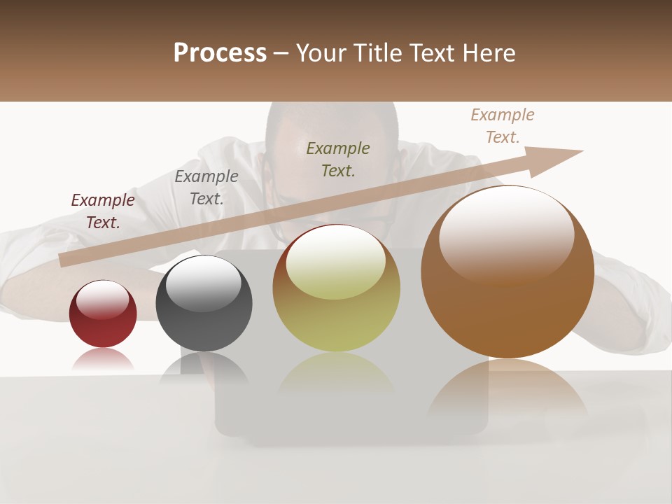 A Man Sitting In Front Of A Laptop Computer PowerPoint Template