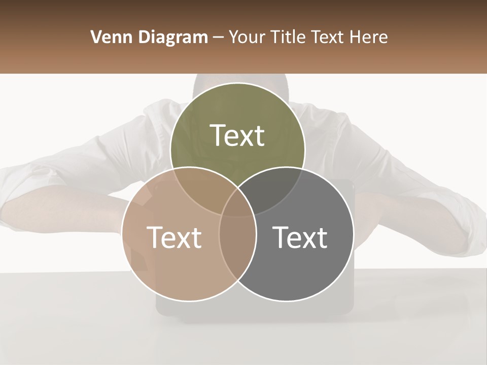 A Man Sitting In Front Of A Laptop Computer PowerPoint Template