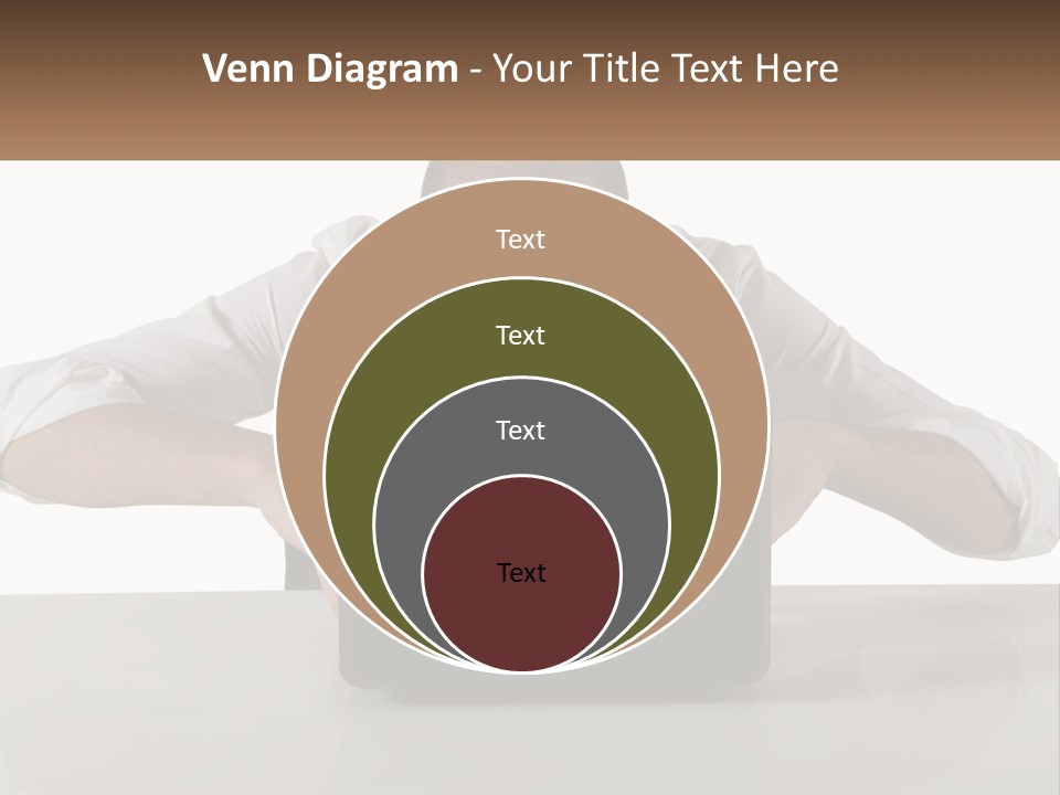 A Man Sitting In Front Of A Laptop Computer PowerPoint Template