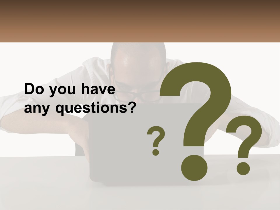 A Man Sitting In Front Of A Laptop Computer PowerPoint Template