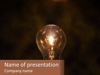 A Light Bulb On Top Of A Wooden Table PowerPoint Template