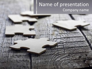 A Group Of Pieces Of A Puzzle On A Wooden Table PowerPoint Template