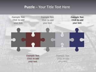 A Group Of Pieces Of A Puzzle On A Wooden Table PowerPoint Template