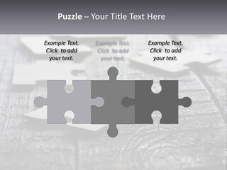 A Group Of Pieces Of A Puzzle On A Wooden Table PowerPoint Template