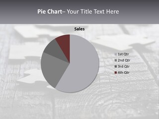 A Group Of Pieces Of A Puzzle On A Wooden Table PowerPoint Template