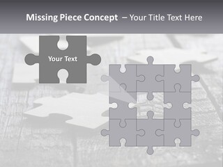 A Group Of Pieces Of A Puzzle On A Wooden Table PowerPoint Template