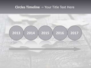 A Group Of Pieces Of A Puzzle On A Wooden Table PowerPoint Template