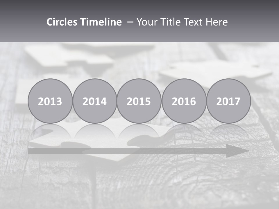 A Group Of Pieces Of A Puzzle On A Wooden Table PowerPoint Template