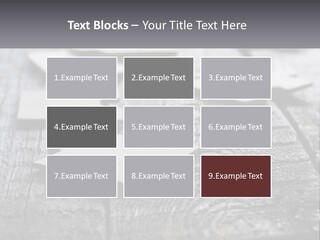 A Group Of Pieces Of A Puzzle On A Wooden Table PowerPoint Template
