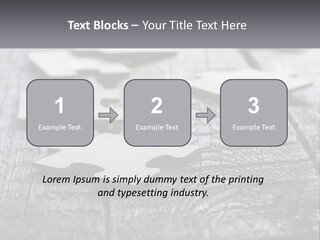 A Group Of Pieces Of A Puzzle On A Wooden Table PowerPoint Template