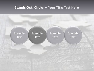 A Group Of Pieces Of A Puzzle On A Wooden Table PowerPoint Template