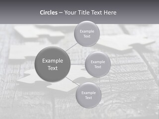 A Group Of Pieces Of A Puzzle On A Wooden Table PowerPoint Template
