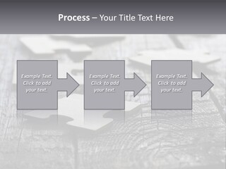 A Group Of Pieces Of A Puzzle On A Wooden Table PowerPoint Template