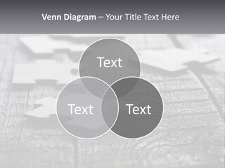 A Group Of Pieces Of A Puzzle On A Wooden Table PowerPoint Template