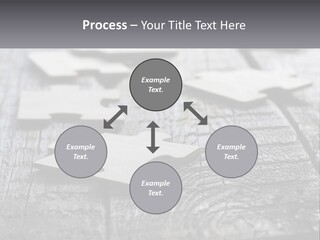 A Group Of Pieces Of A Puzzle On A Wooden Table PowerPoint Template