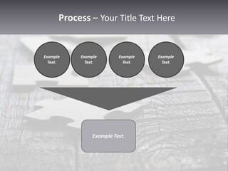 A Group Of Pieces Of A Puzzle On A Wooden Table PowerPoint Template