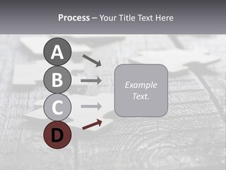 A Group Of Pieces Of A Puzzle On A Wooden Table PowerPoint Template