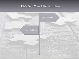 A Group Of Pieces Of A Puzzle On A Wooden Table PowerPoint Template
