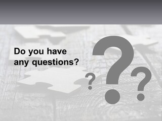 A Group Of Pieces Of A Puzzle On A Wooden Table PowerPoint Template