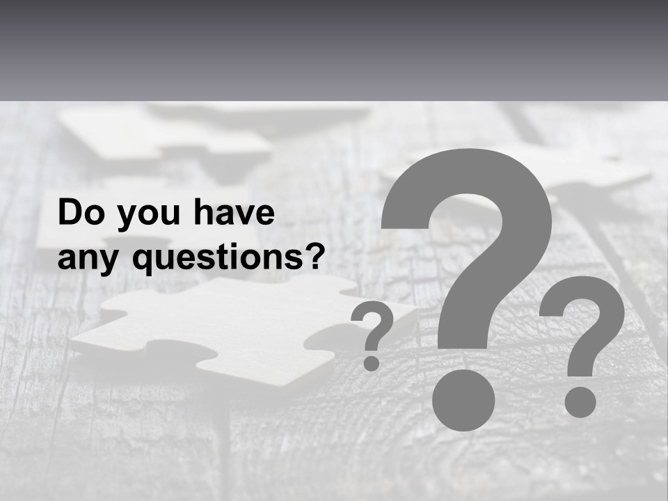 A Group Of Pieces Of A Puzzle On A Wooden Table PowerPoint Template