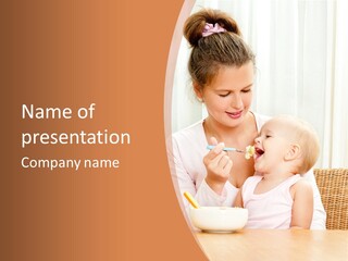 A Woman Feeding A Baby With A Spoon PowerPoint Template