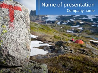 A Large Rock With A Red Cross Painted On It PowerPoint Template