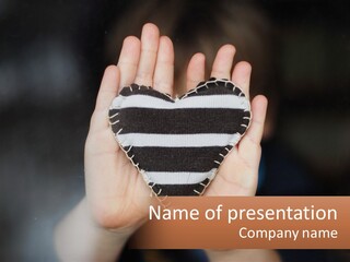 A Person Holding A Heart Shaped Object In Their Hands PowerPoint Template