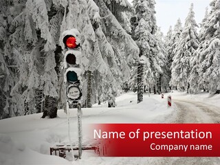 A Stop Light On A Snowy Road With Trees In The Background PowerPoint Template