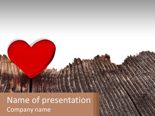 A Red Heart Sitting On Top Of A Wooden Table PowerPoint Template