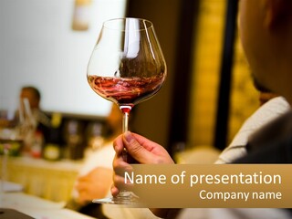 A Person Holding A Glass Of Wine In Their Hand PowerPoint Template
