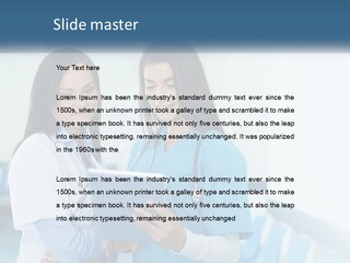 Two Women In Scrubs Are Looking At A Tablet PowerPoint Template