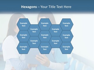 Two Women In Scrubs Are Looking At A Tablet PowerPoint Template