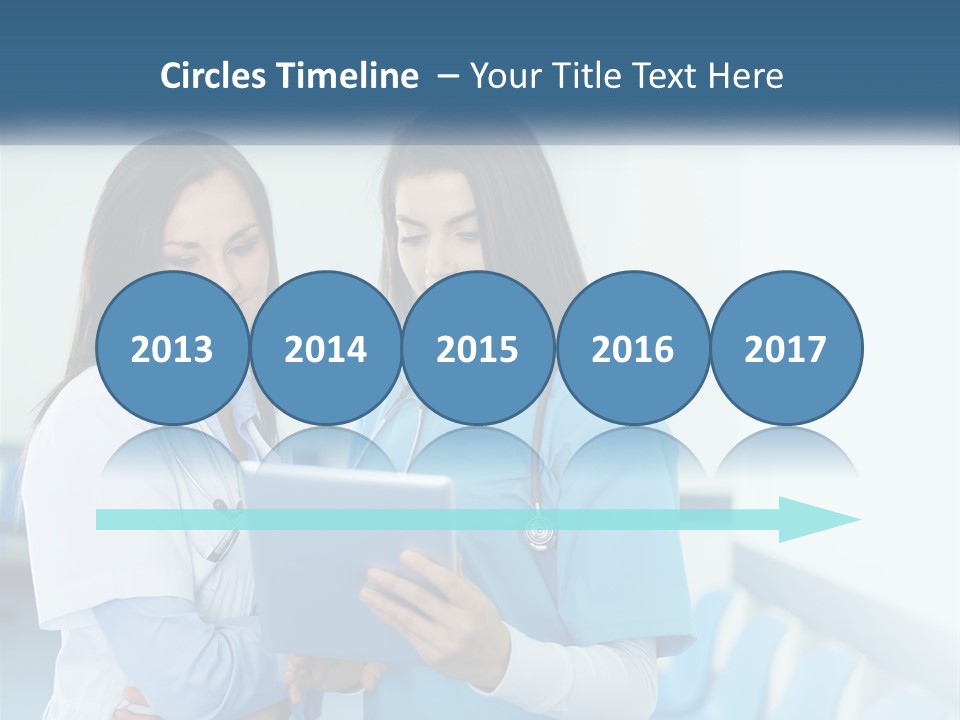 Two Women In Scrubs Are Looking At A Tablet PowerPoint Template