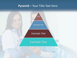 Two Women In Scrubs Are Looking At A Tablet PowerPoint Template