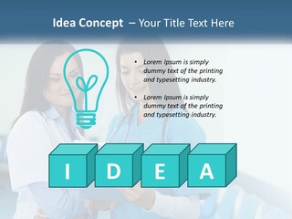 Two Women In Scrubs Are Looking At A Tablet PowerPoint Template