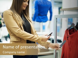 A Woman Looking At A Cell Phone In A Clothing Store PowerPoint Template