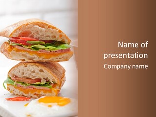 A Couple Of Sandwiches Sitting On Top Of A White Plate PowerPoint Template