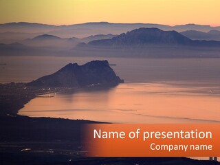 A Large Body Of Water Surrounded By Mountains PowerPoint Template