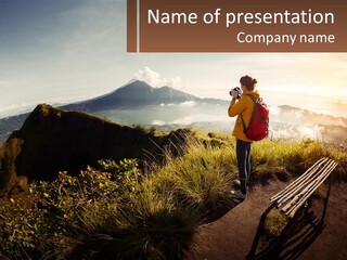A Person Taking A Picture Of A Mountain With A Camera PowerPoint Template