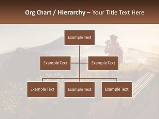 A Person Taking A Picture Of A Mountain With A Camera PowerPoint Template