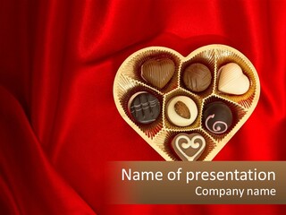 A Heart Shaped Box Filled With Chocolates On A Red Cloth PowerPoint Template