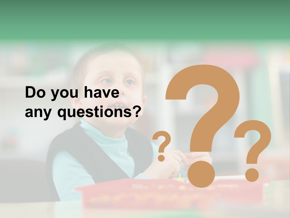 A Young Boy Is Sitting At A Table PowerPoint Template